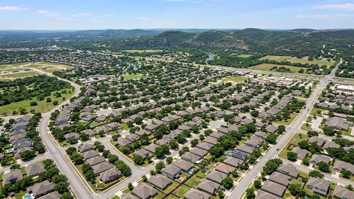 Natural daytime aerial of New Braunfels residential blocks and Hill Country edges. Used for market-update and neighborhood-overview posts.